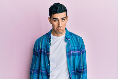 Günlük kıyafetler giyen yakışıklı İspanyol bunalımlı ve sıkıntılı, sinirli ve korkmuş. hüzünlü ifade. 