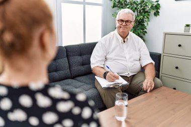 Senior psychologist man at consultation office with a happy and cool smile on face. lucky person. 