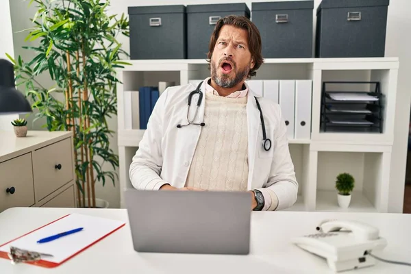 Handsome Middle Age Doctor Man Working Clinic Shock Face Looking — Stockfoto