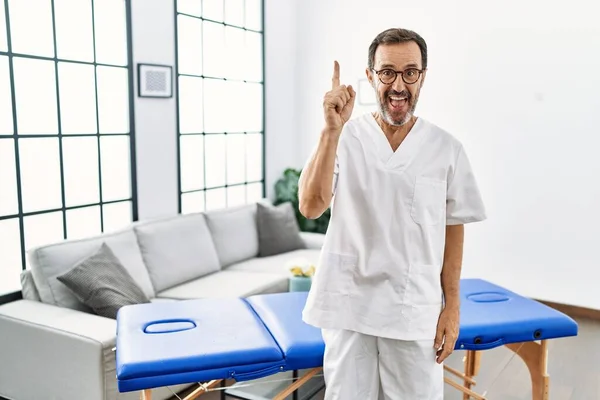 Middle Age Physiotherapy Man Working Home Pointing Finger Successful Idea — Stockfoto