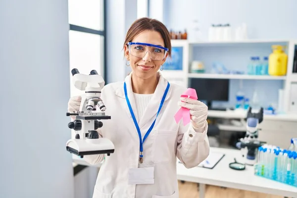Young Brunette Woman Working Scientist Laboratory Holding Pink Ribbon Relaxed — Fotografia de Stock