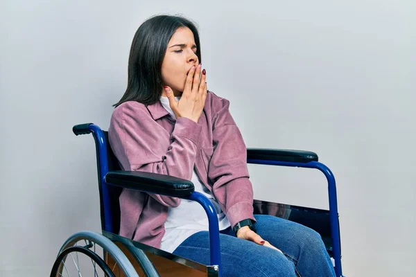 Young Brunette Woman Sitting Wheelchair Bored Yawning Tired Covering Mouth — Foto Stock