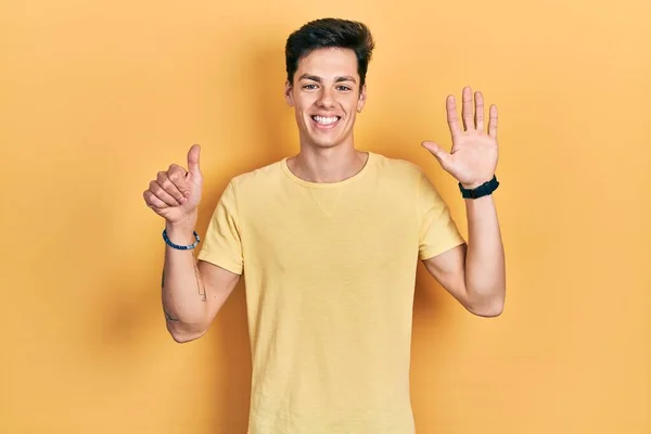 Νεαρός Ισπανόφωνος Φοράει Κίτρινο Μπλουζάκι Που Δείχνει Και Δείχνει Δάχτυλα — Φωτογραφία Αρχείου