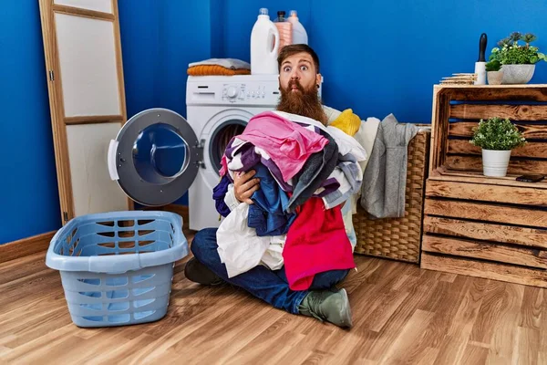 Redhead Man Long Beard Putting Dirty Laundry Washing Machine Making — Φωτογραφία Αρχείου