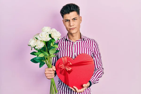 Young Hispanic Man Holding Anniversary Present Bouquet Flowers Skeptic Nervous — 스톡 사진