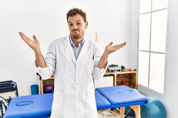 Handsome Young Man Working Pain Recovery Clinic Clueless Confused Expression — Stockfoto