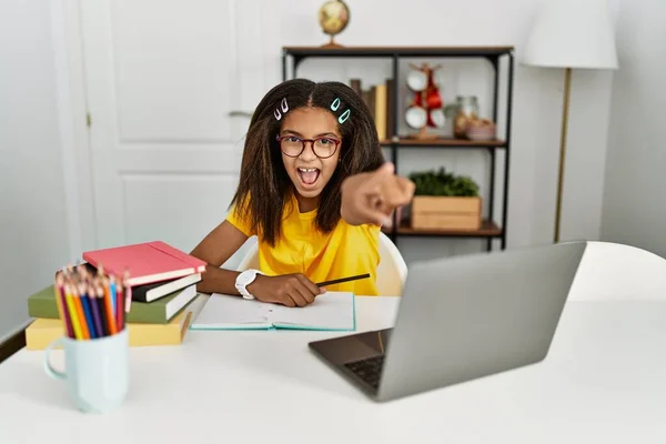 Young African American Girl Doing Homework Home Pointing Displeased Frustrated — Stok fotoğraf