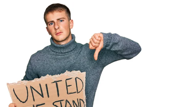 Young Blond Man Holding United Stand Banner Angry Face Negative — 图库照片
