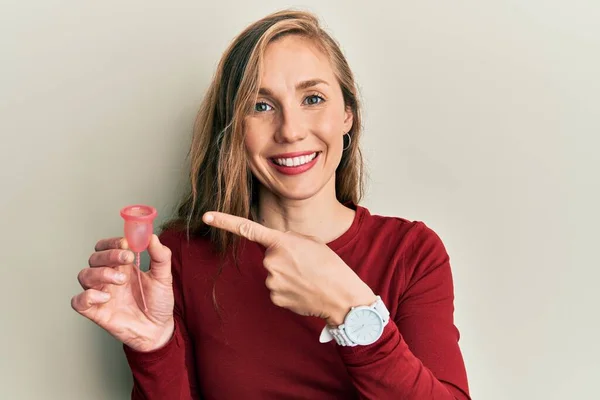 Young Blonde Woman Holding Menstrual Cup Smiling Happy Pointing Hand — Stok fotoğraf