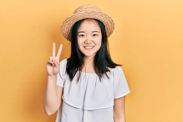 Young Chinese Girl Wearing Summer Hat Smiling Happy Face Winking — Stockfoto