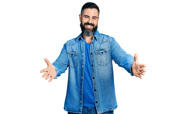 Hispanic Man Beard Wearing Casual Denim Jacket Looking Camera Smiling — Zdjęcie stockowe