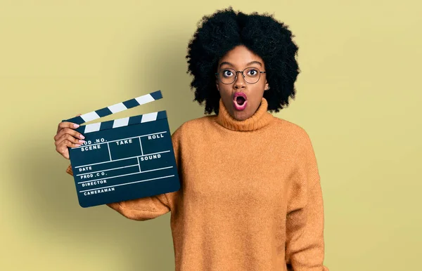 Young African American Woman Holding Video Film Clapboard Scared Amazed — Stockfoto