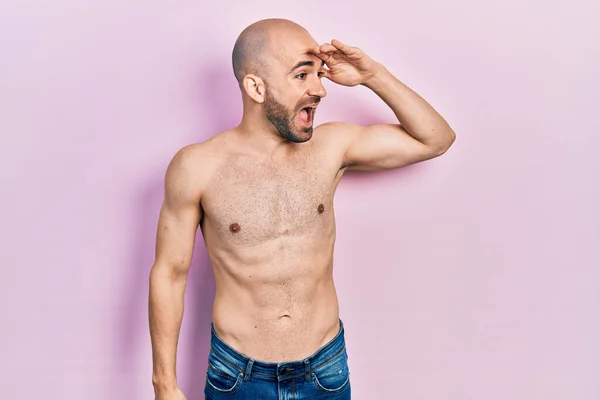 Young Bald Man Standing Shirtless Very Happy Smiling Looking Far — 图库照片