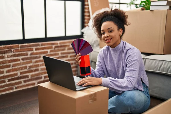 Young African American Woman Smiling Confident Choosing Paint Color New — стоковое фото