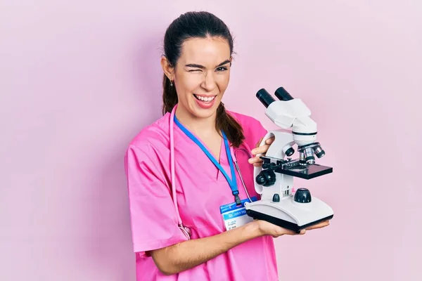 Young Brunette Woman Holding Microscope Winking Looking Camera Sexy Expression — Foto Stock