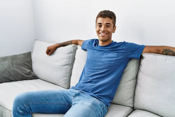 Young Hispanic Man Relaxing Sitting Sofa Home — Foto de Stock