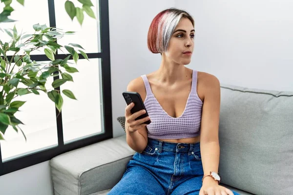 Young Beautiful Woman Using Smartphone Typing Message Sitting Sofa Looking — Fotografia de Stock