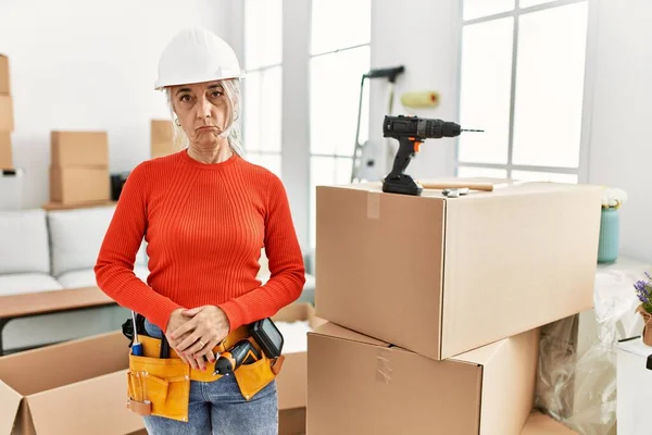 Middle Age Grey Haired Woman Wearing Hardhat Standing New Home — стоковое фото