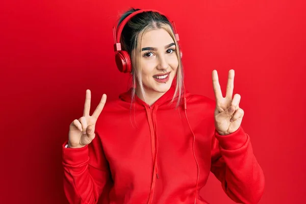 Young Modern Girl Wearing Gym Clothes Using Headphones Smiling Looking — Foto Stock