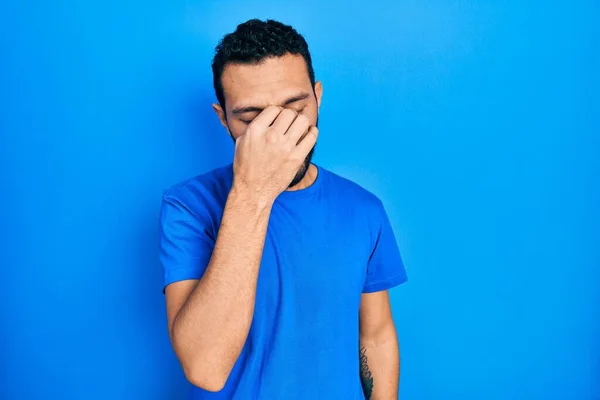 Hispanic Man Beard Wearing Casual Blue Shirt Tired Rubbing Nose — Stockfoto
