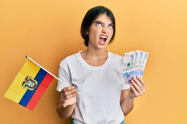Young Caucasian Woman Holding Colombia Flag Colombian Pesos Banknotes Angry — Stock fotografie
