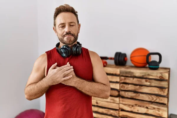 Middle Age Man Wearing Sportswear Headphones Gym Smiling Hands Chest — Stok fotoğraf