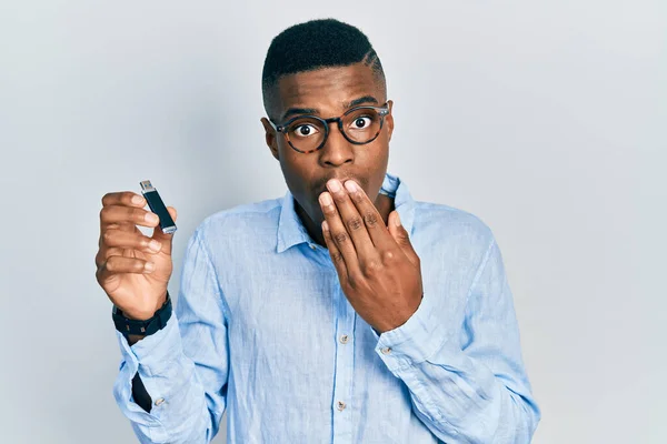 Young African American Man Holding Removable Memory Usb Covering Mouth — Stok fotoğraf