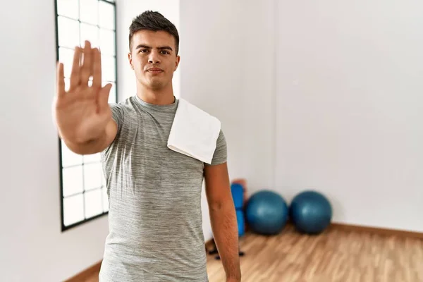 Young Hispanic Man Wearing Sportswear Towel Gym Doing Stop Sing — Stok fotoğraf