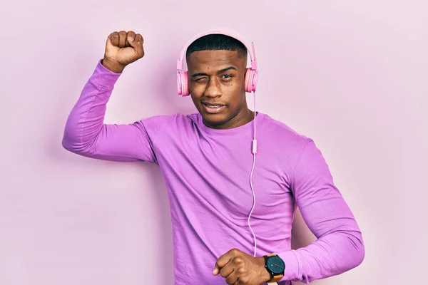 Young Black Man Dancing Listening Music Using Headphones Winking Looking —  Fotos de Stock