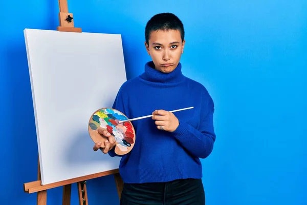 Beautiful Hispanic Woman Short Hair Holding Paintbrush Palette Depressed Worry —  Fotos de Stock