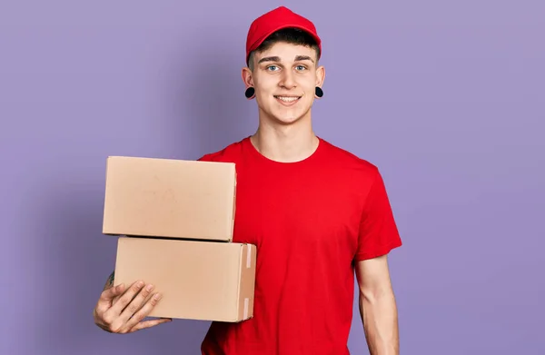 Young Caucasian Boy Ears Dilation Holding Delivery Package Looking Positive — Foto Stock