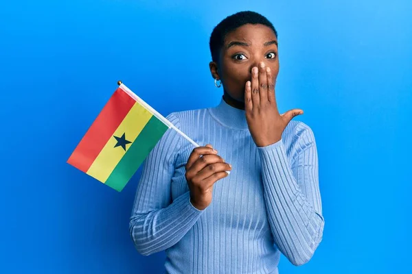 Young African American Woman Holding Ghana Flag Covering Mouth Hand — стоковое фото