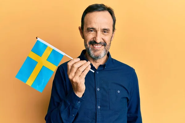 Middle Age Hispanic Man Holding Sweden Flag Looking Positive Happy — Stok fotoğraf