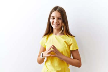 Young brunette teenager standing together over isolated background hands together and fingers crossed smiling relaxed and cheerful. success and optimistic 