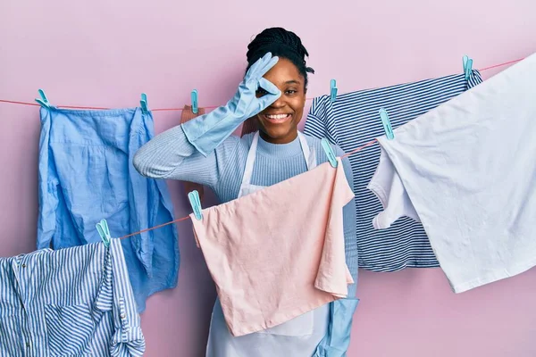 African American Woman Braided Hair Washing Clothes Clothesline Doing Gesture — стокове фото