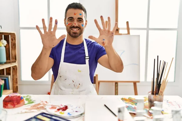 Young Hispanic Man Beard Art Studio Painted Face Showing Pointing — стоковое фото