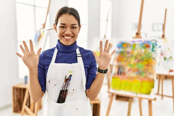 Young Brunette Woman Art Studio Showing Pointing Fingers Number Ten — Stok fotoğraf