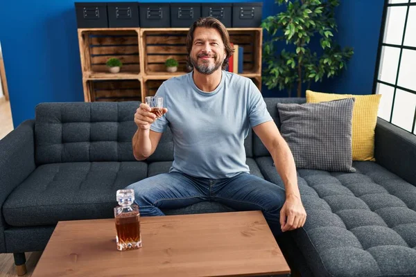Handsome Middle Age Man Drinking Glass Whiskey Sitting Sofa Looking — Stockfoto