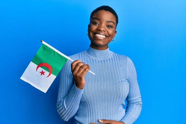 Young African American Woman Holding Algeria Flag Looking Positive Happy — Stockfoto