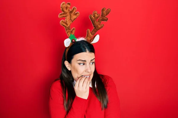 Young Hispanic Woman Wearing Cute Christmas Reindeer Horns Looking Stressed — Stock fotografie