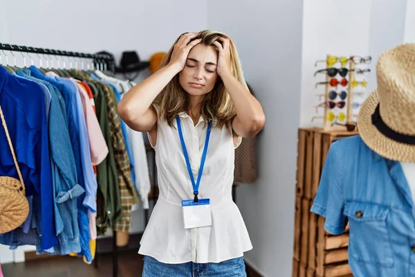 Young Blonde Woman Working Manager Retail Boutique Suffering Headache Desperate — Stock Photo, Image
