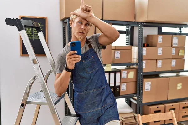 Young Blond Man Using Smartphone Working Storehouse Making Fun People — Foto Stock