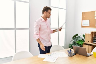 Young hispanic man working at office
