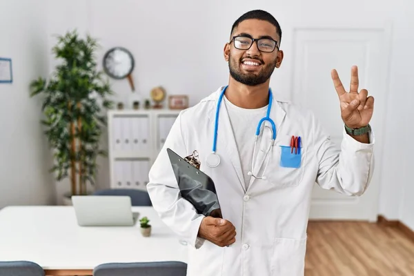 Young Indian Man Wearing Doctor Uniform Stethoscope Smiling Looking Camera — Stockfoto