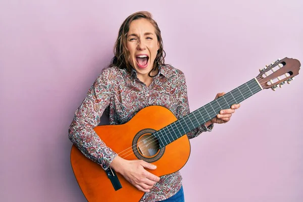 Young Blonde Woman Playing Classical Guitar Smiling Laughing Hard Out — Stok fotoğraf