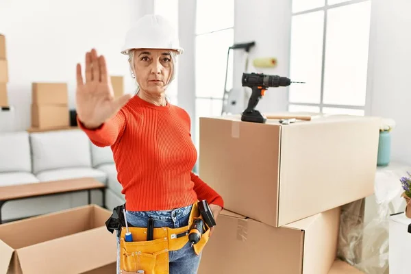 Middle Age Grey Haired Woman Wearing Hardhat Standing New Home — стоковое фото