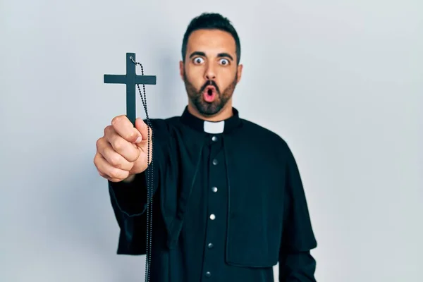 Handsome Hispanic Priest Man Beard Holding Catholic Cross Scared Amazed — Stok fotoğraf