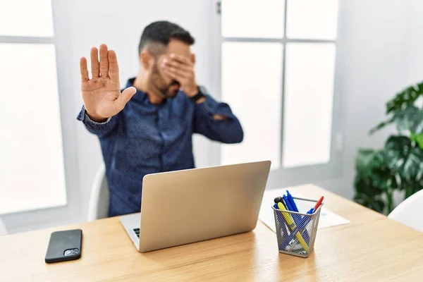 Young Hispanic Man Beard Working Office Laptop Covering Eyes Hands — Stockfoto