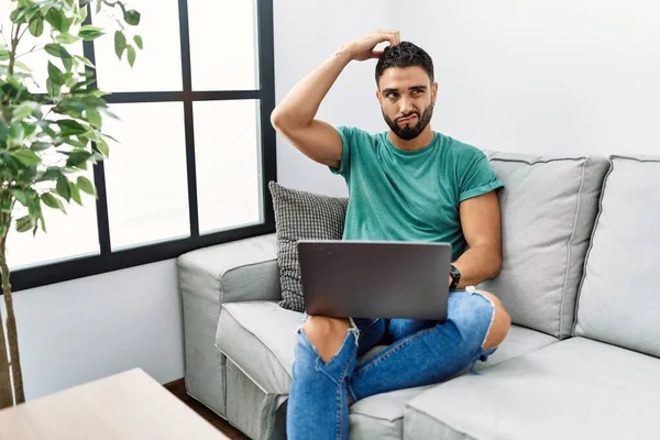 Young Handsome Man Beard Using Computer Laptop Sitting Sofa Home — Stock fotografie