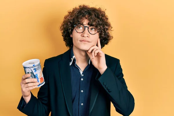 Handsome Young Man Holding Piggy Bank Serious Face Thinking Question — Stockfoto